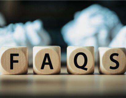 Wooden blocks spelling &lsquo;FAQS&rsquo; placed on a desk, representing frequently asked questions related to GST compliance, tax updates, and regulatory guidance.