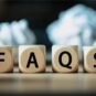 Wooden blocks spelling ‘FAQS’ placed on a desk, representing frequently asked questions related to GST compliance, tax updates, and regulatory guidance.